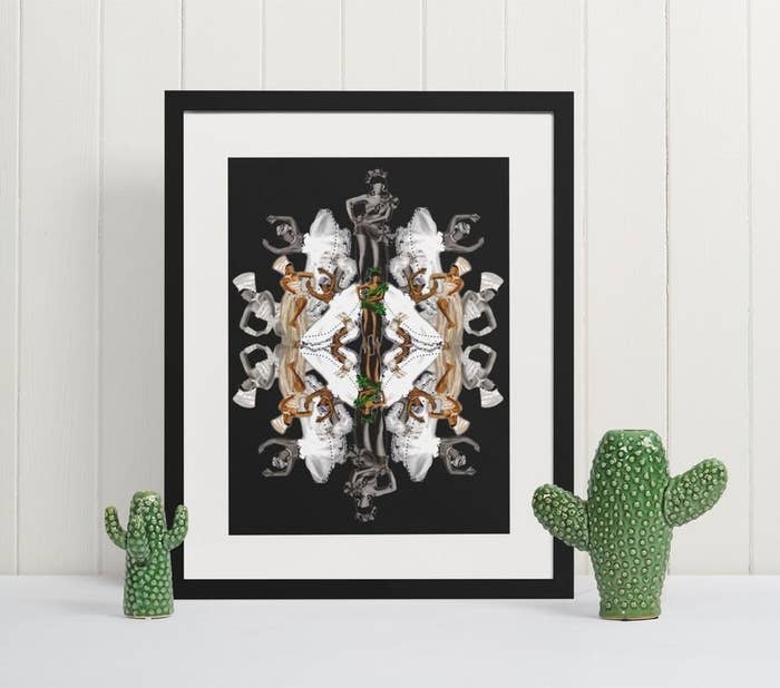 The print in a frame next to two cute cacti 