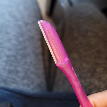 reviewer showing the blade of the touch-up tool