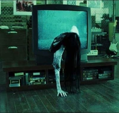 A scary girl coming through a haunted TV