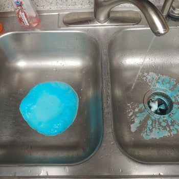 reviewer photo showing the disposer cleaner bubbling up through the drains of their kitchen sink 