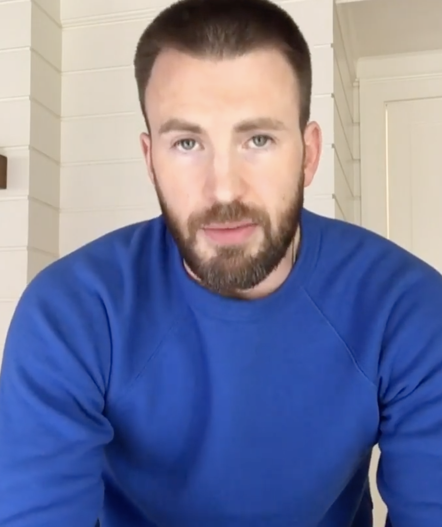 Chris Evans filming a selfie video for his Instagram account in a sweater and a beard