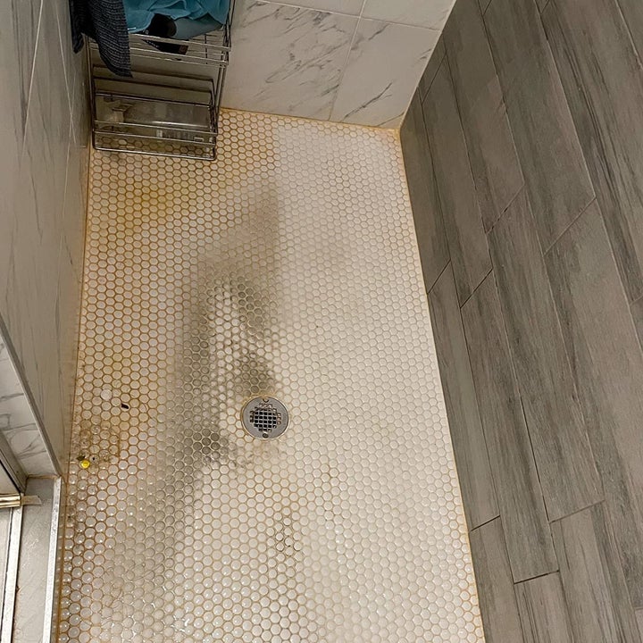 reviewer photo showing their shower tile completely covered in grime and mildew