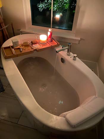 Reviewer showing their bath with the pillow