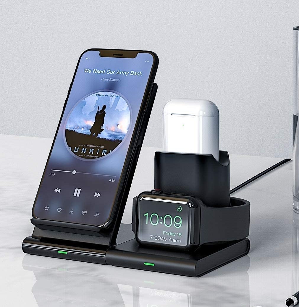 a phone, apple watch, and airpods on the charging dock
