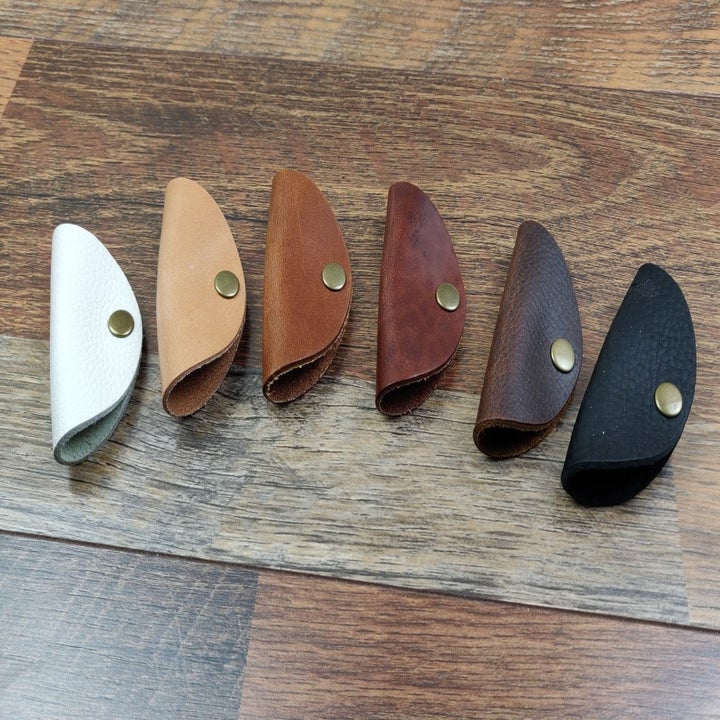 The "taco" in various leather shades of white, beige, brown, and black 