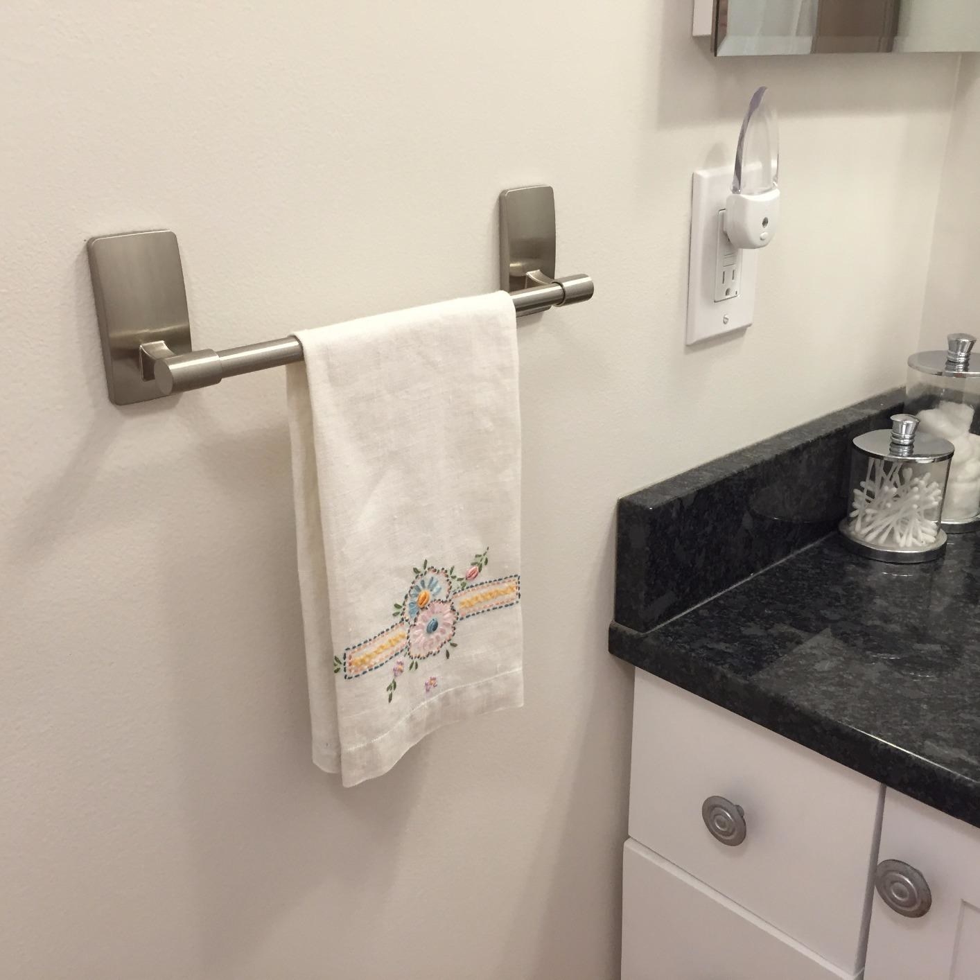 the silvery towel bar mounted on a reviewer's wall