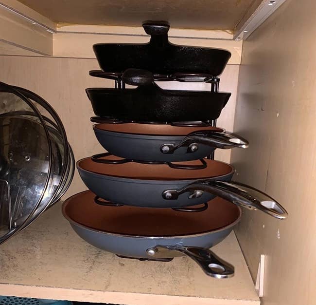 reviewer photo showing their pots and pans neatly stacked on the organizer