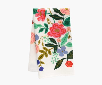 a white tea towel with colorful florals on it