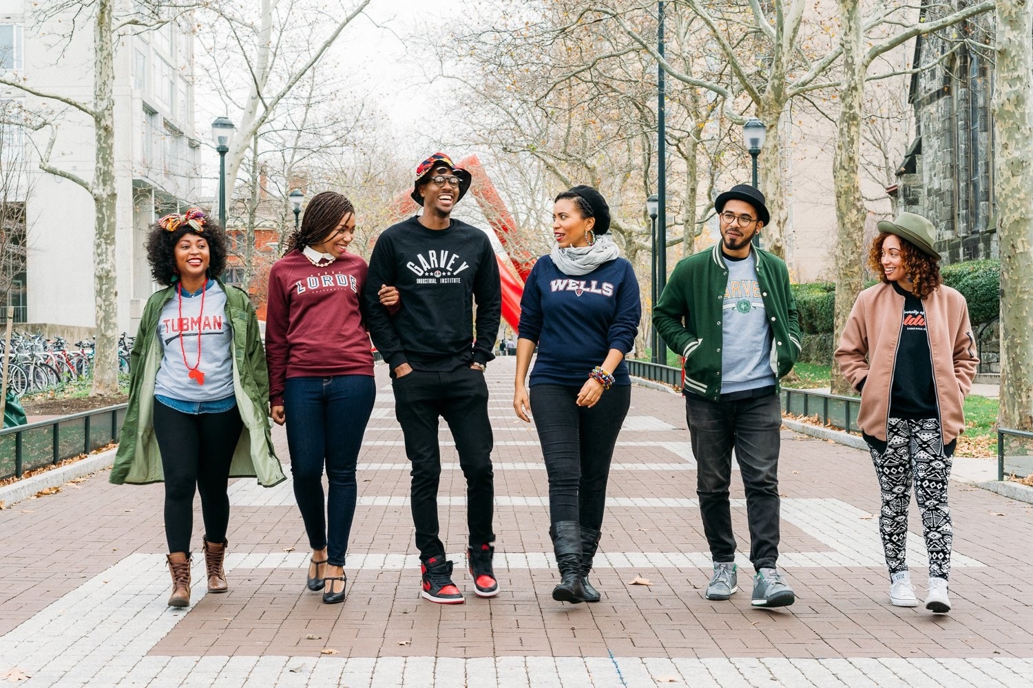 A group of people wearing crewnecks from the shop