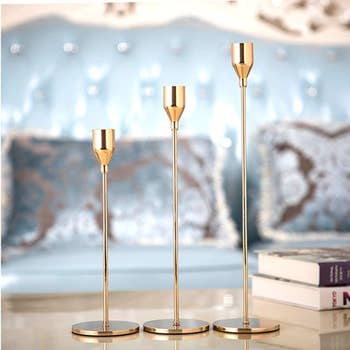 three candle stick holders in varying heights