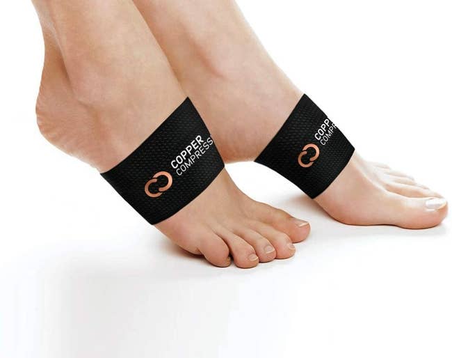 A model wearing a pair of Copper Compression Arch Support sleeves on their feet