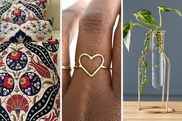 Patterned pillow covers, a hear-shaped ring, and a plant in a cute vial