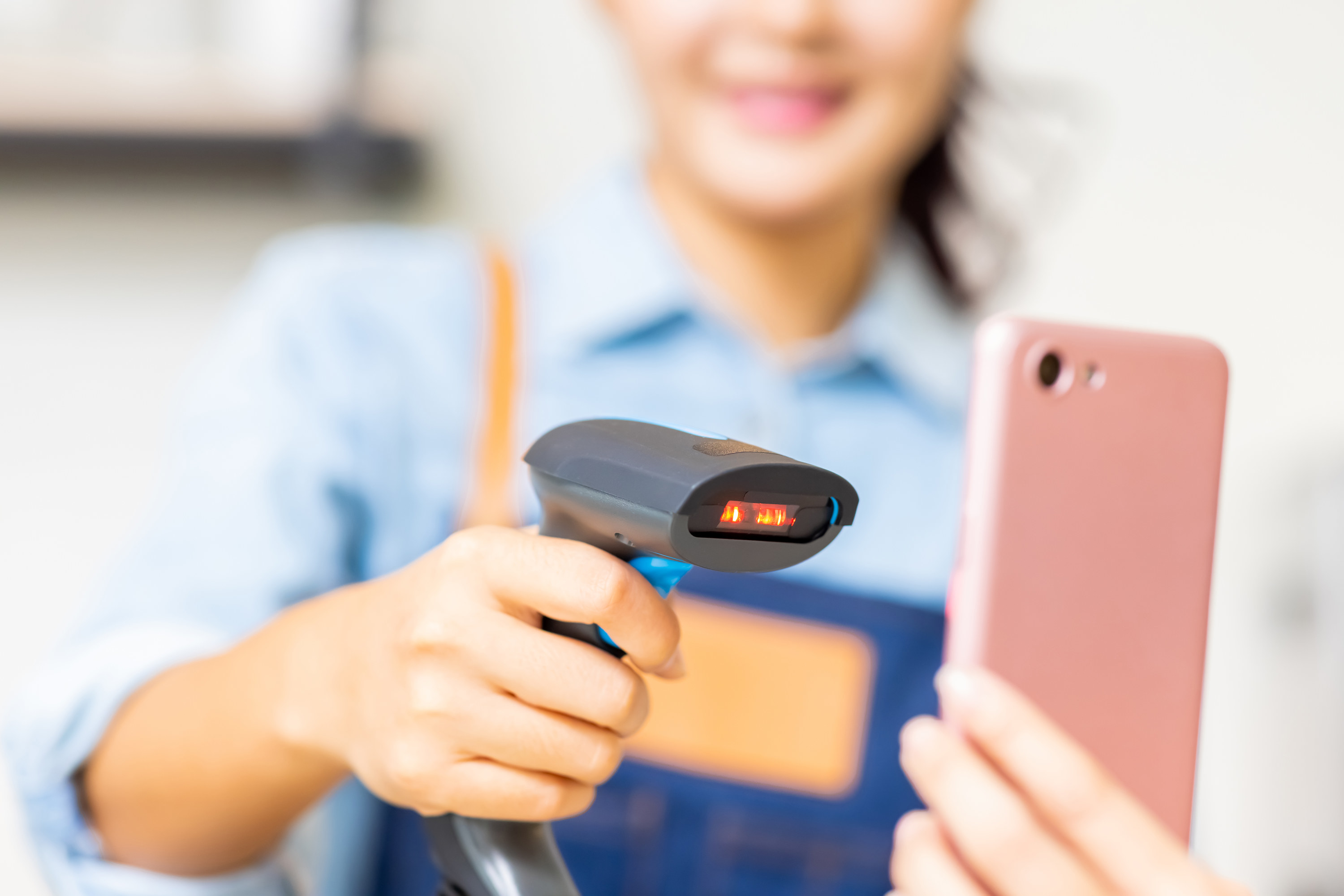 A cashier scanning a person&#x27;s phone