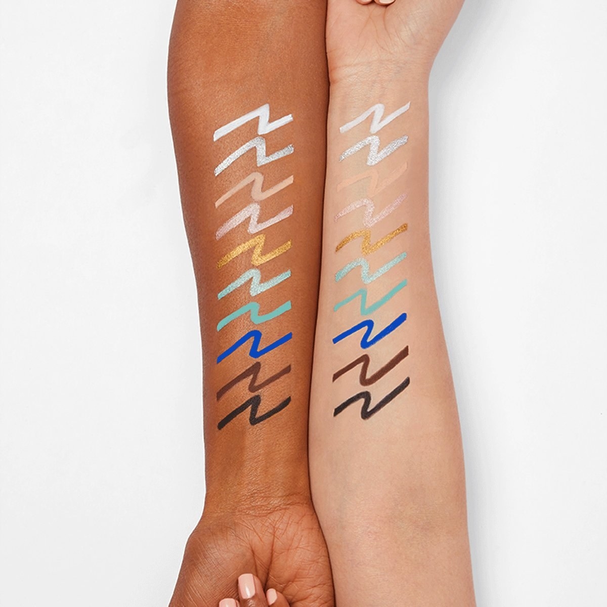 dark skin model and light skin model with all the colorful eyeliner colors swatched on their forearms