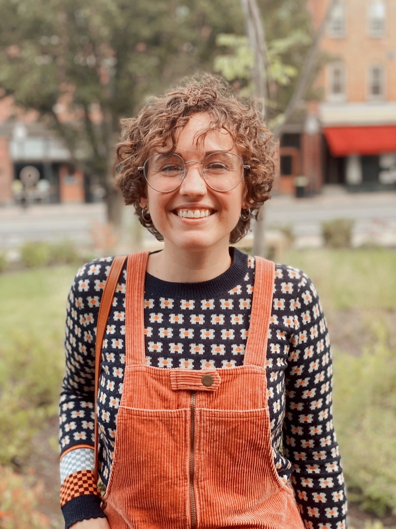 A person with a perm smiling