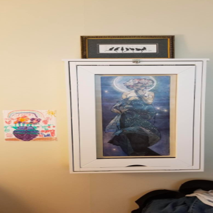the same reviewer's photo of the desk while folded into the wall with artwork on it 