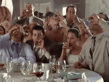 People drinking shots at a wedding