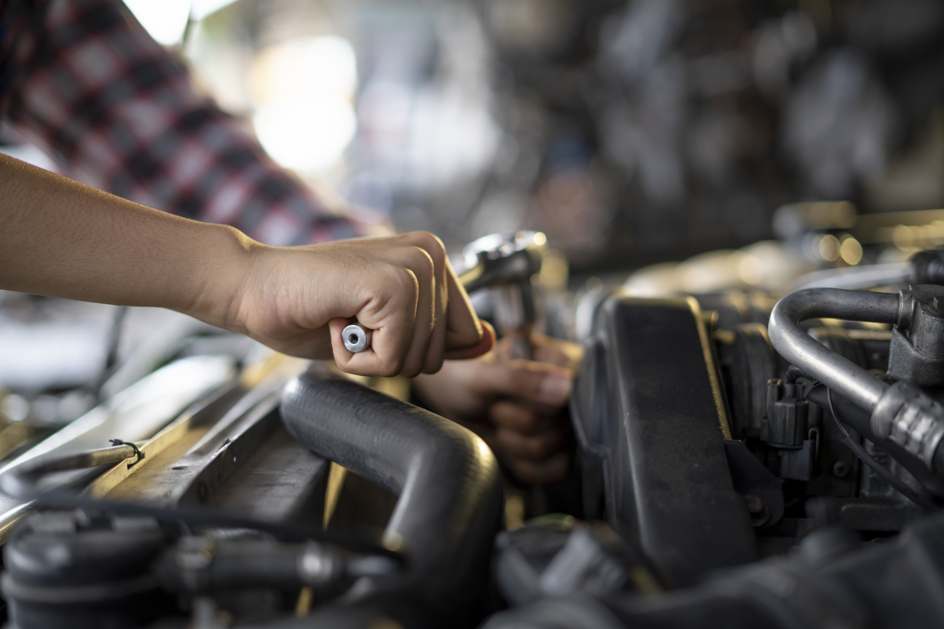 Someone working on a car engine