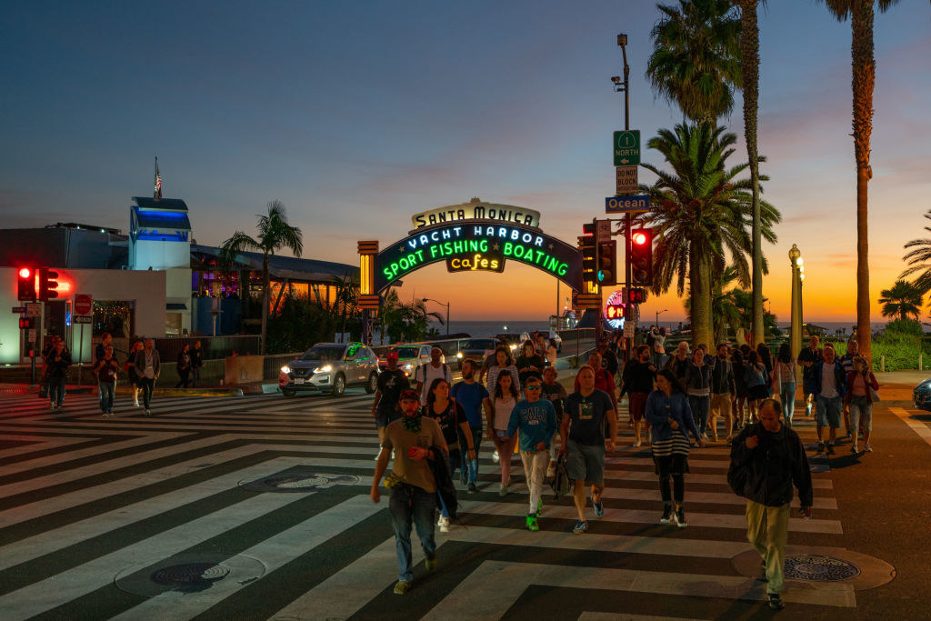 People crossing the street by the pier