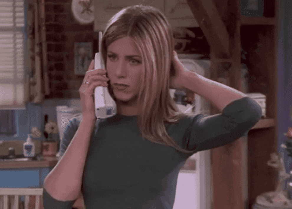 Rachel looks shocked while talking on the phone