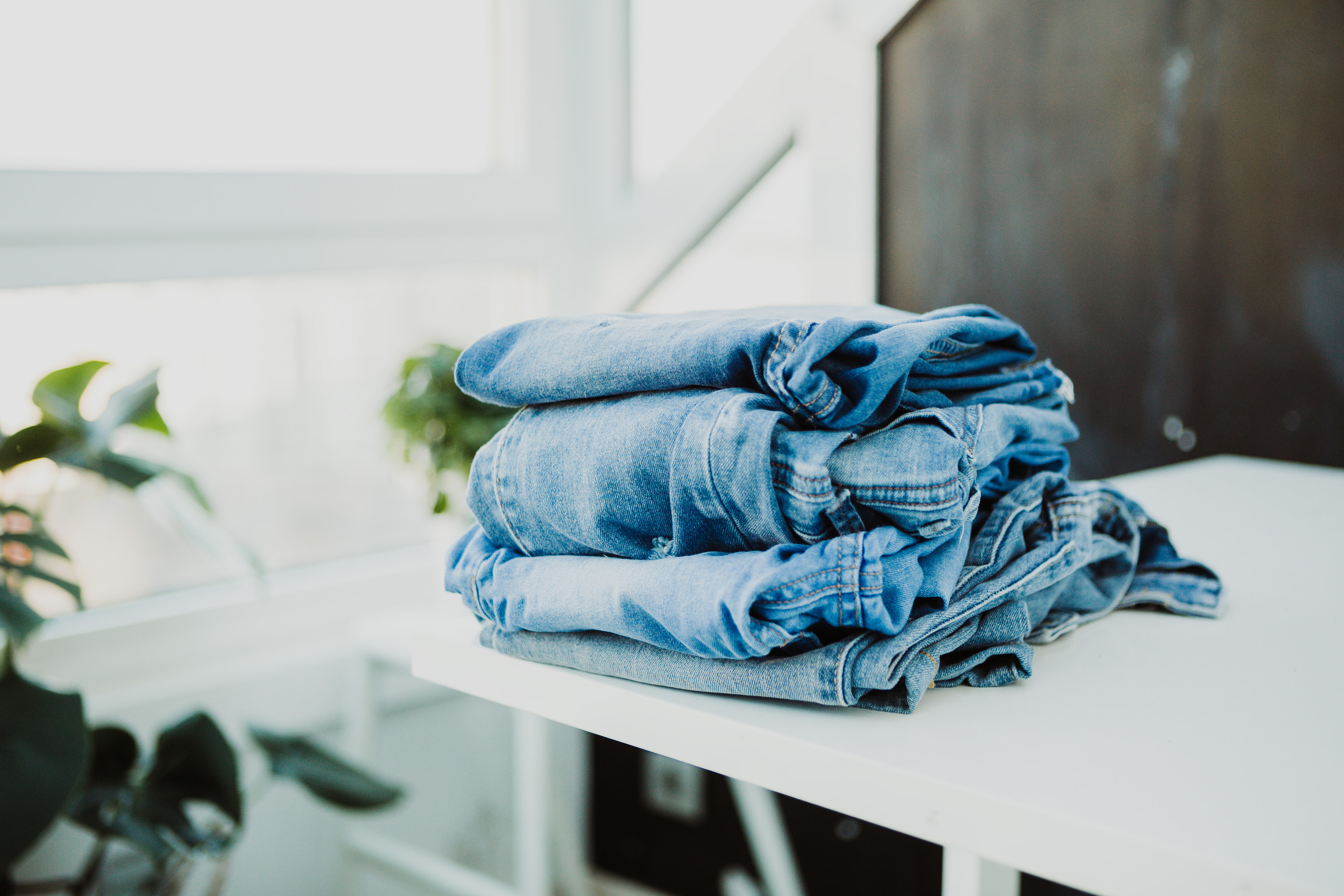 Pile of denim jeans