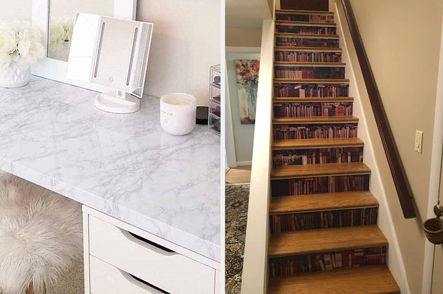to the left: a marbled desk, to the right: stairs lined with faux bookcases in between each one