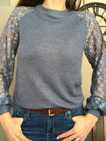 a reviewer wearing the top in blue