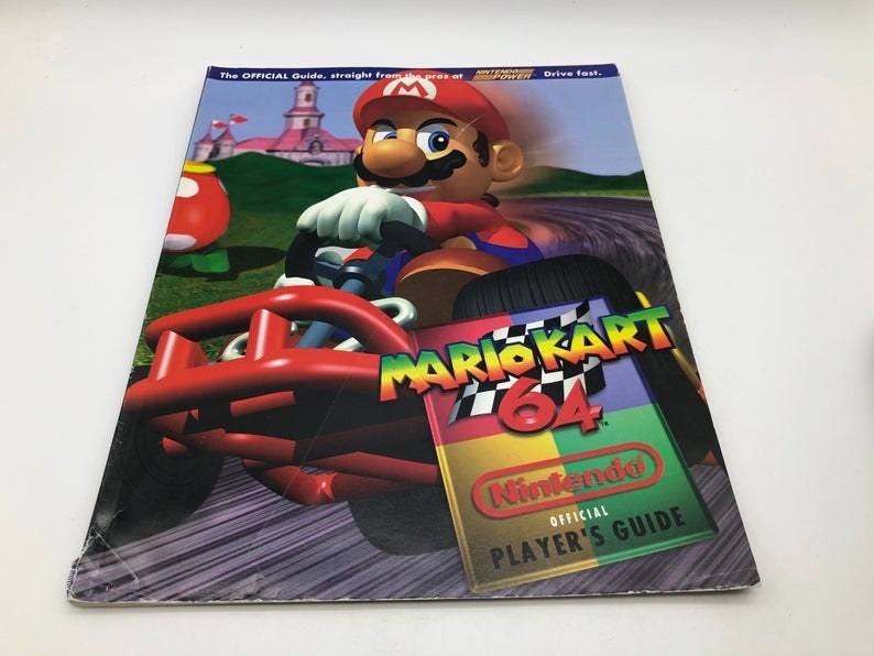 A Players Guide for Mario Kart 64 with Mario driving a kart on the cover