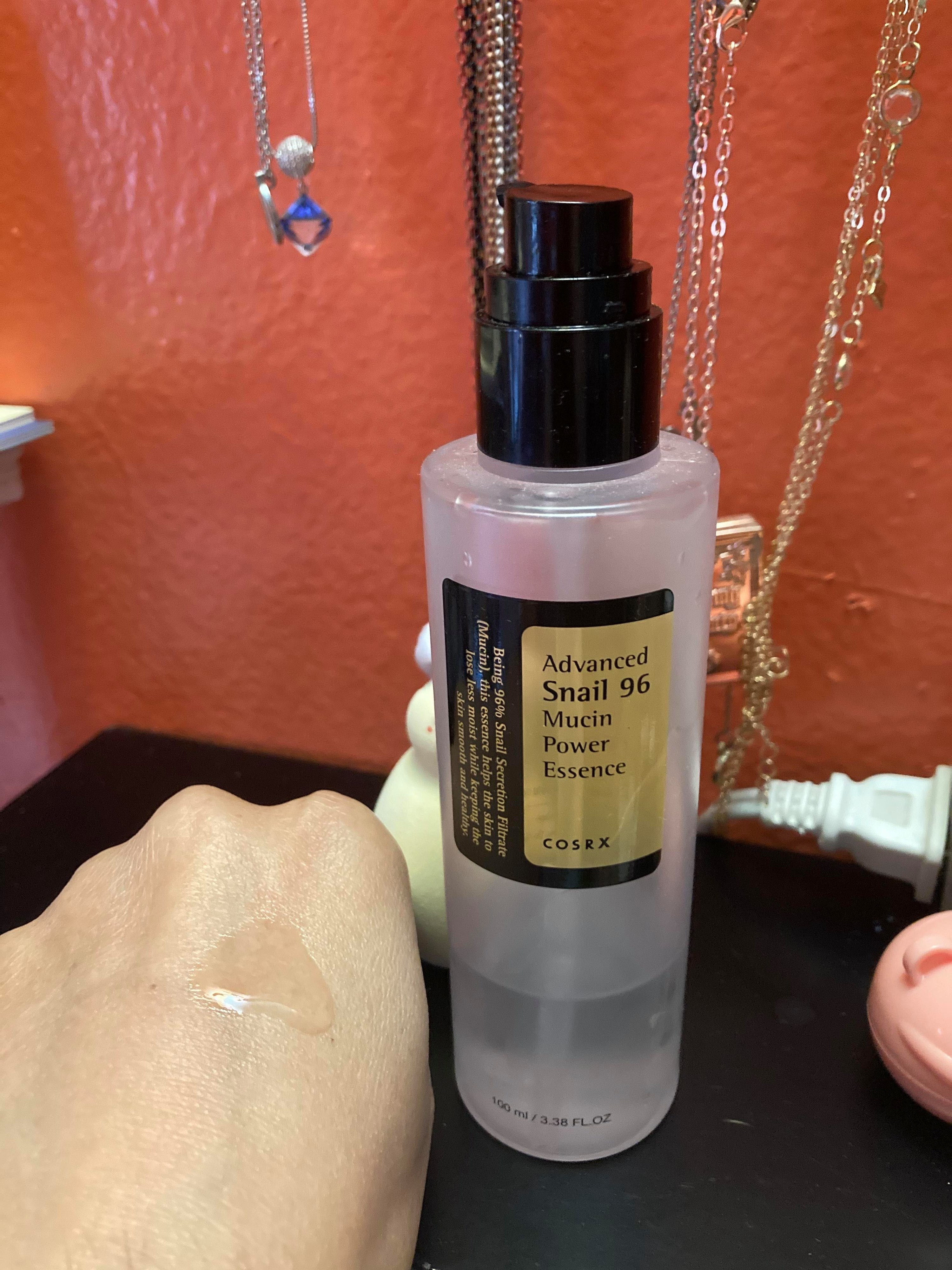 the bottle with swatch of the liquid texture on hand