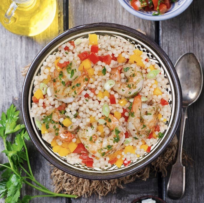 bowl full of Pesto shrimp with Israeli couscous and peppers