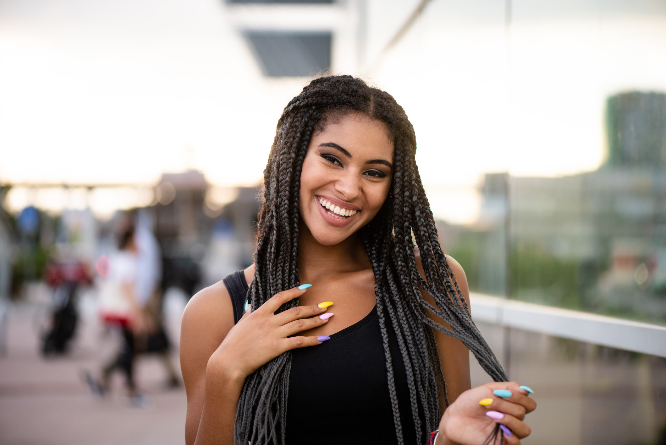 Teenage girl with multicolored nail polish and braid hairstyle