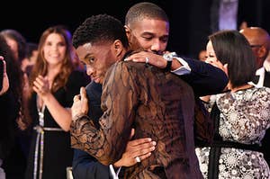 Chadwick and Michael hug on stage