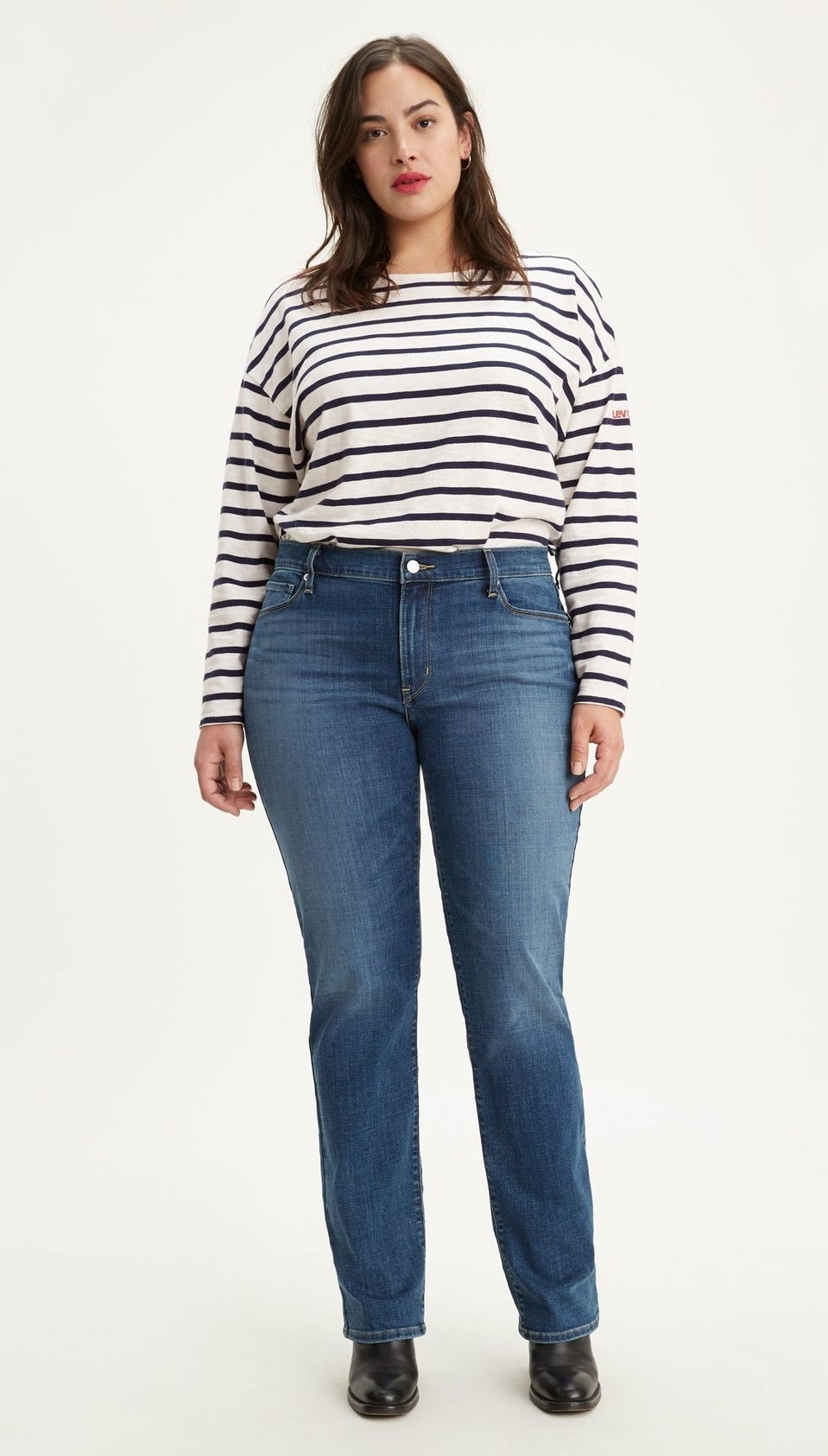 model wearing straight leg blue jeans