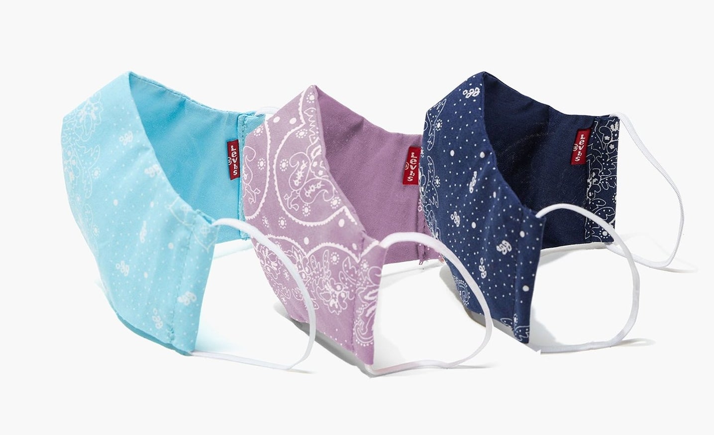 three bandana printed face masks in light blue, purple, and navy