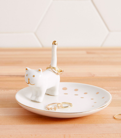 A ceramic trinket tray with a cat on one end as the ring holder