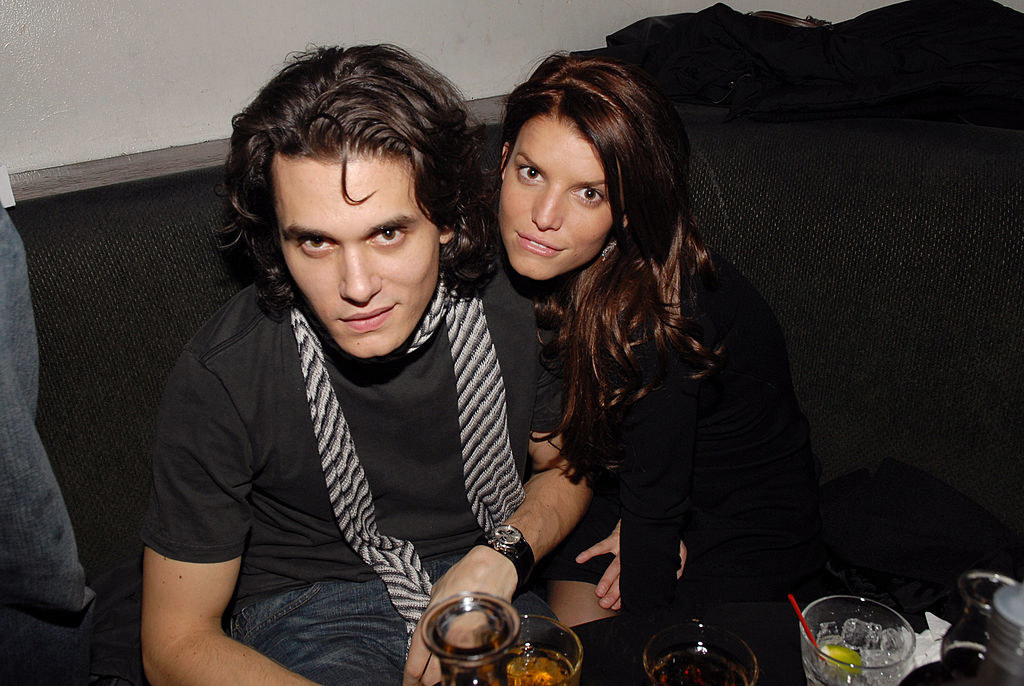 John Mayer and Jessica Simpson at a table with drinks