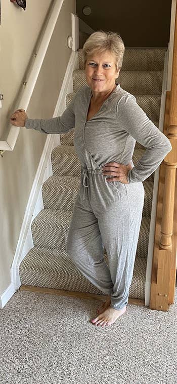 reviewer wearing the jumpsuit in grey