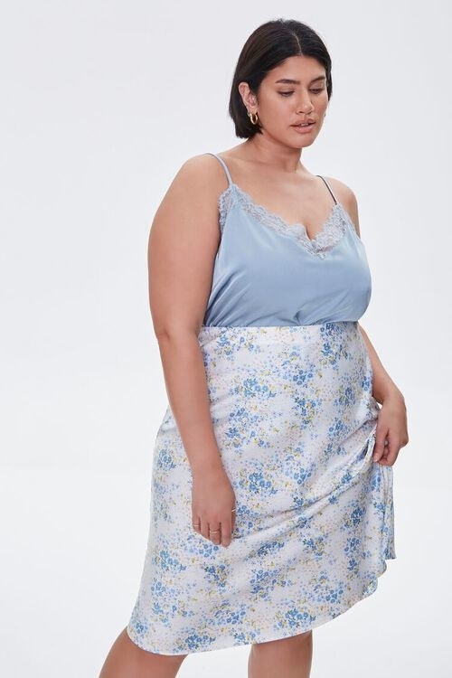 Model wearing the blue and white floral mid-length skirt