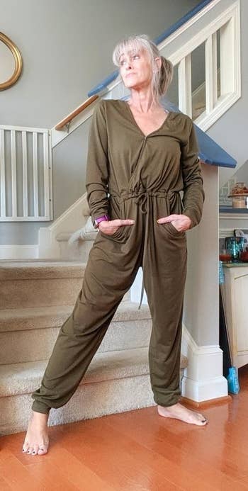 reviewer wearing the jumpsuit in green