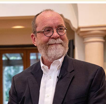 photographer john dyer smiling while looking away at the camera