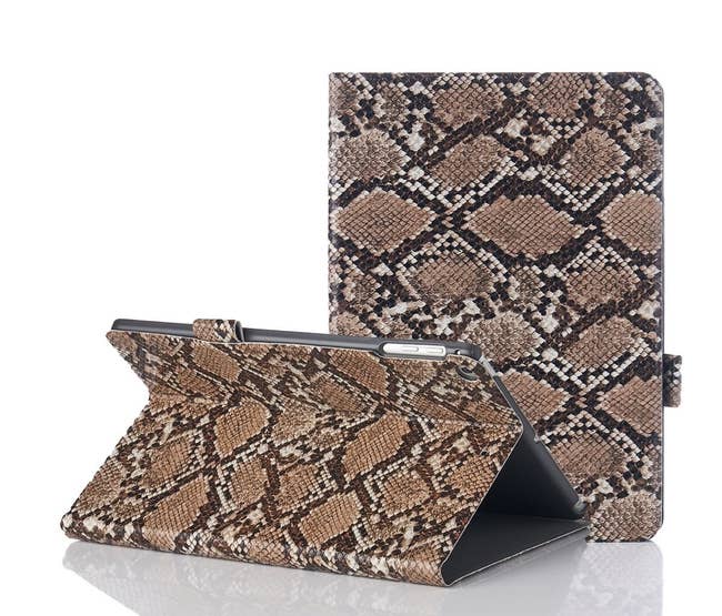 the brown snakeskin case shown closed around an ipad and folded to serve as a stand for a horizontal iPad
