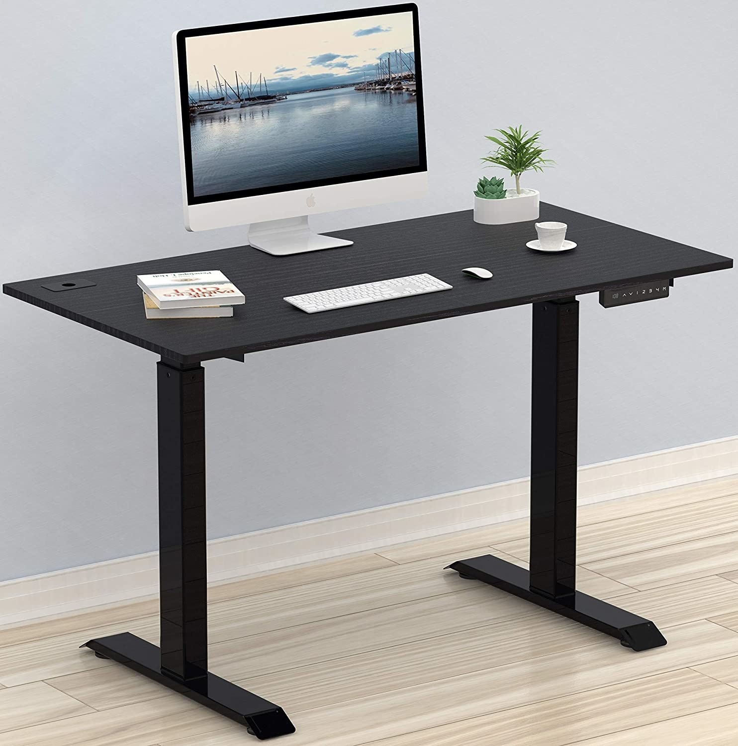 the standing desk with a computer and keyboard on it