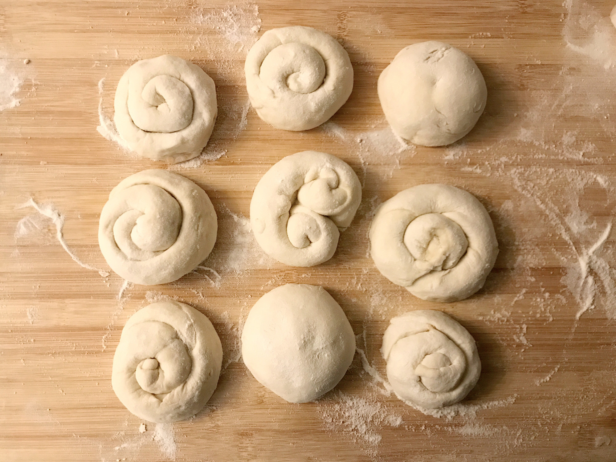 Balls of dough on a floured surface.