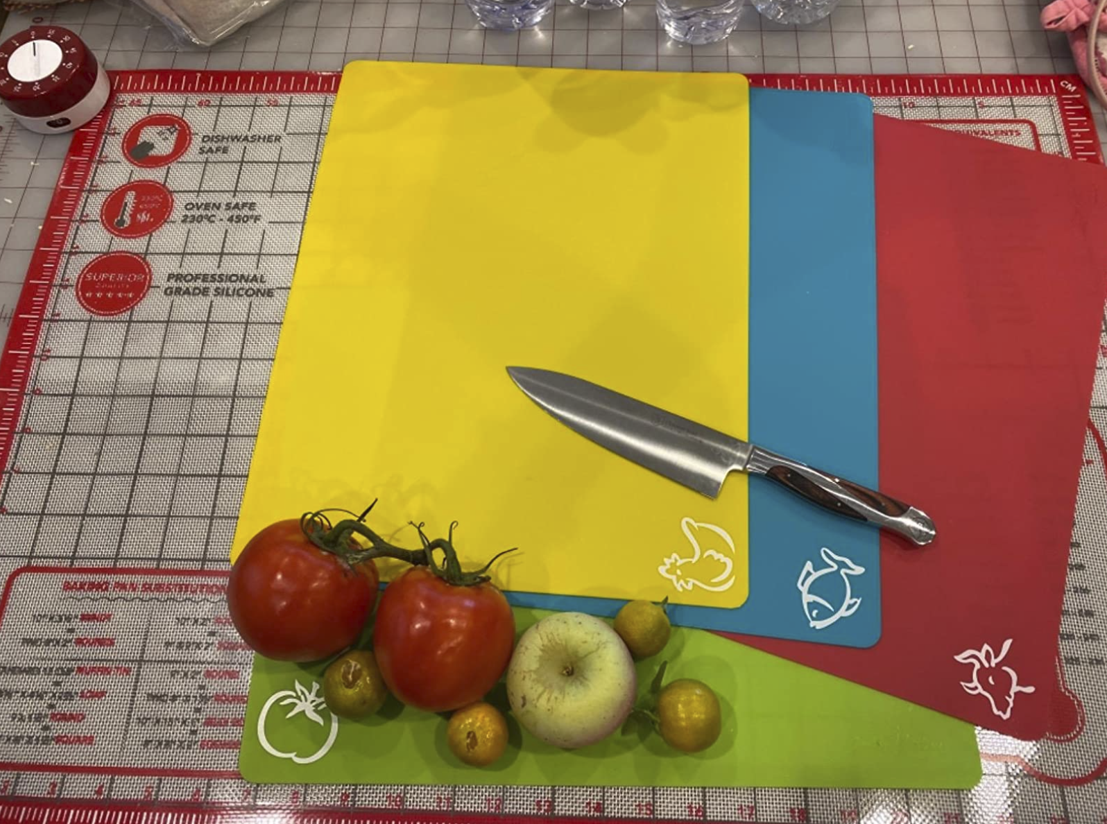 reviewer&#x27;s four mats with vegetables and a kitchen knife sitting on top of them
