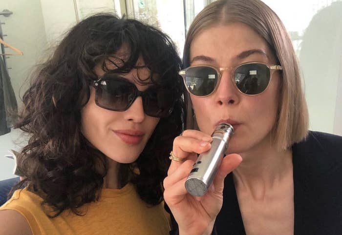 Eiza González in sunglasses as Fran posing with Rosamund Pike, also in sunglasses, as Marla