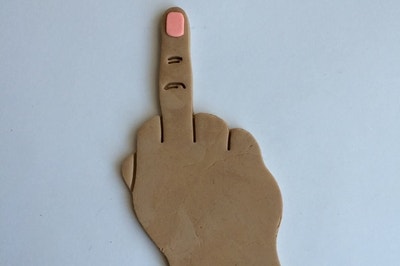 Cookie dough cut out to look like a hand giving the finger 