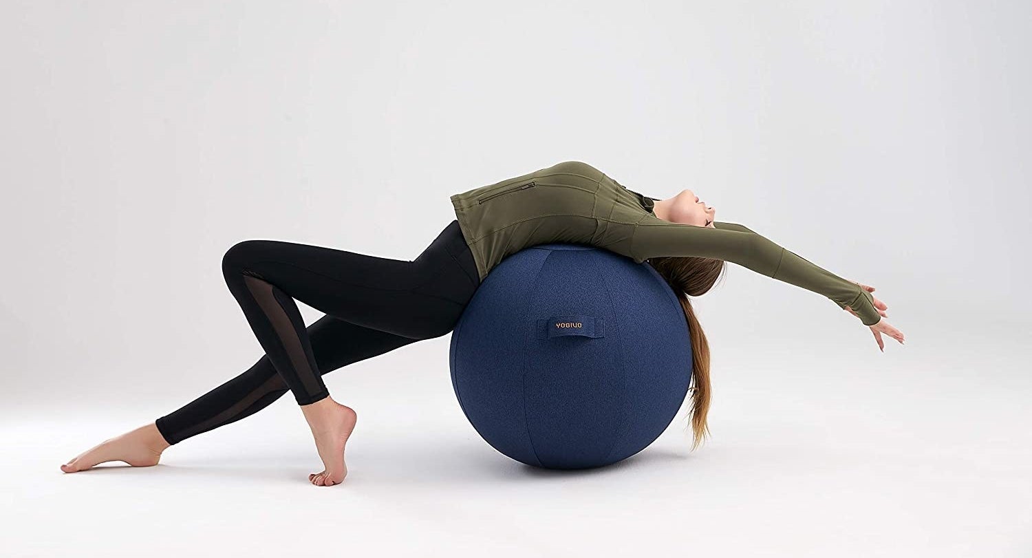 A person stretching over an exercise ball with a neat cover