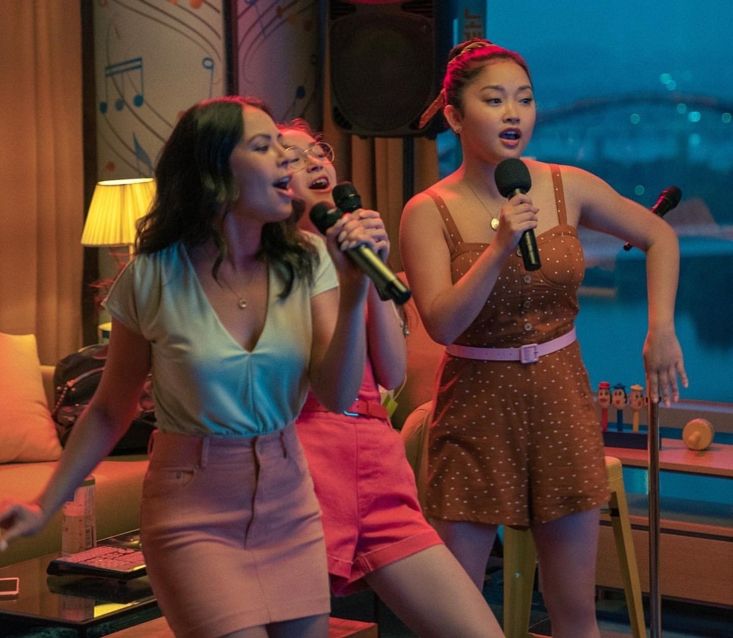 Lara Jean, Kitty, and Margot singing karaoke 