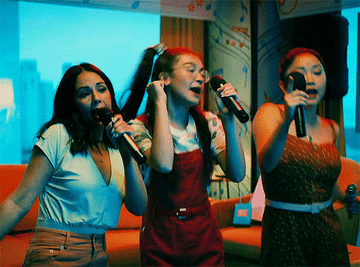Kitty, Margot, and Lara Jean singing karaoke 
