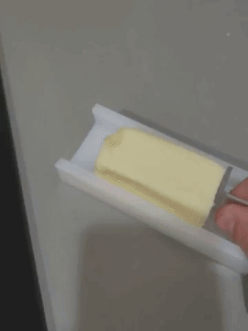 Model using butter grip to apply butter to hot pan